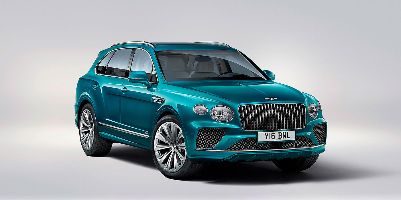 Bentley Manchester Bentley Bentayga Azure front three-quarter view, featuring a fluted chrome grille with a matrix lower grille and chrome accents in Topaz blue paint.