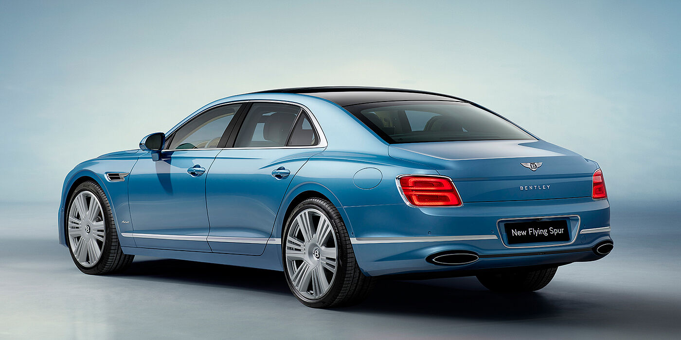 Bentley Manchester New Bentley Flying Spur Azure sedan rear view in Light windsor blue by Mulliner paint with 22 inch Azure wheels and chrome exterior details