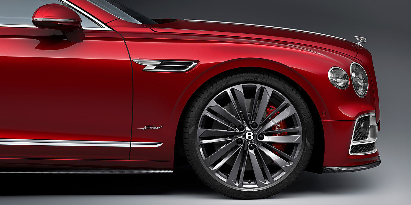 Bentley Manchester Bentley Flying Spur Speed sedan front wheel in close up with Dragon Red II paint