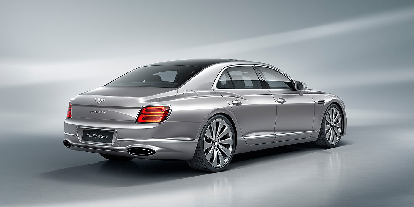 Bentley Manchester New Bentley Flying Spur sedan rear view in Silverlake paint with ten spoke wheels and chrome matrix grille