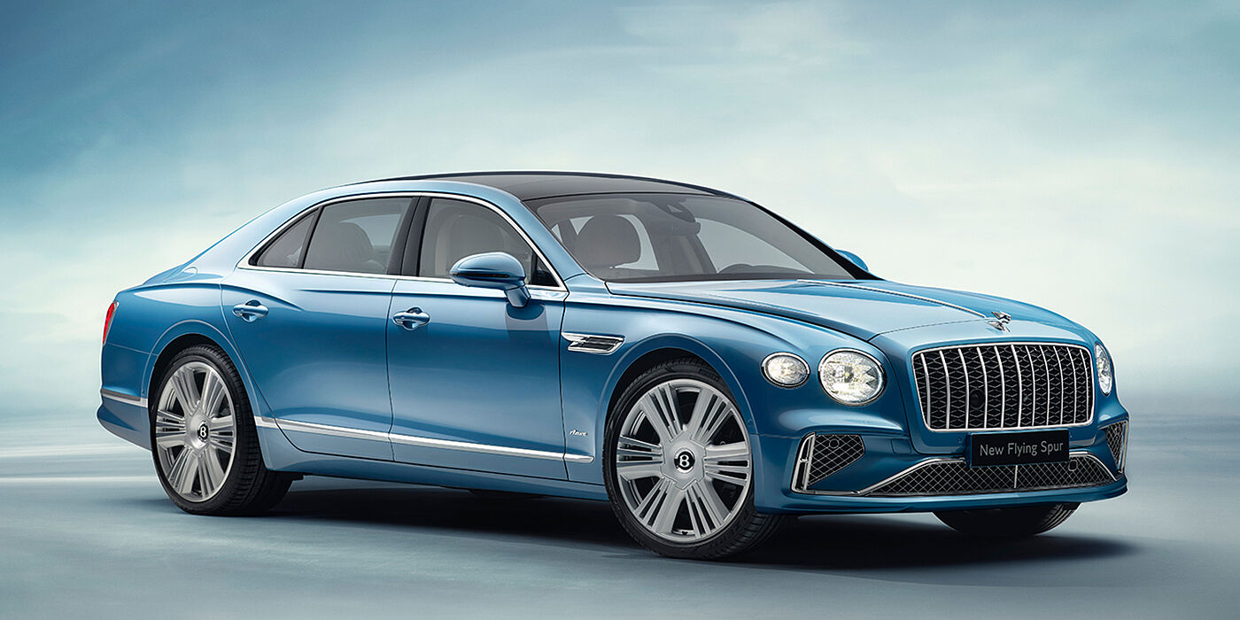 Bentley Manchester New Bentley Flying Spur Azure sedan front view in Light windsor blue by Mulliner paint with 22 inch Azure wheels and chrome exterior details