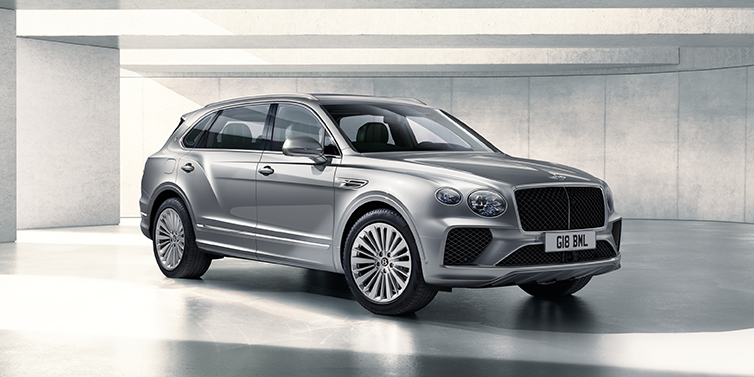 Bentley Manchester Bentley Bentayga Extended Wheelbase SUV front three quarter in Moonbeam paint with a grey background