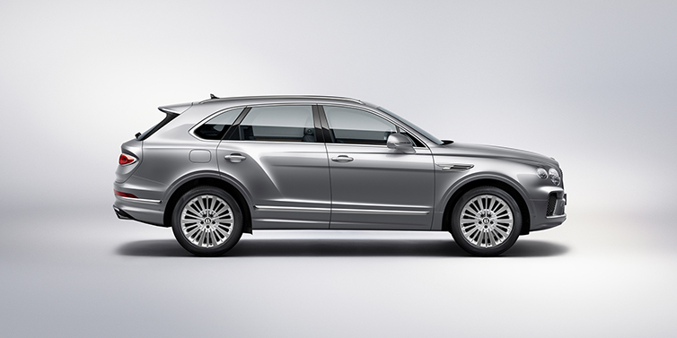Bentley Manchester Bentley Bentayga SUV side profile in Moonbeam silver paint against white background featuring 21 inch 5 spoke wheels